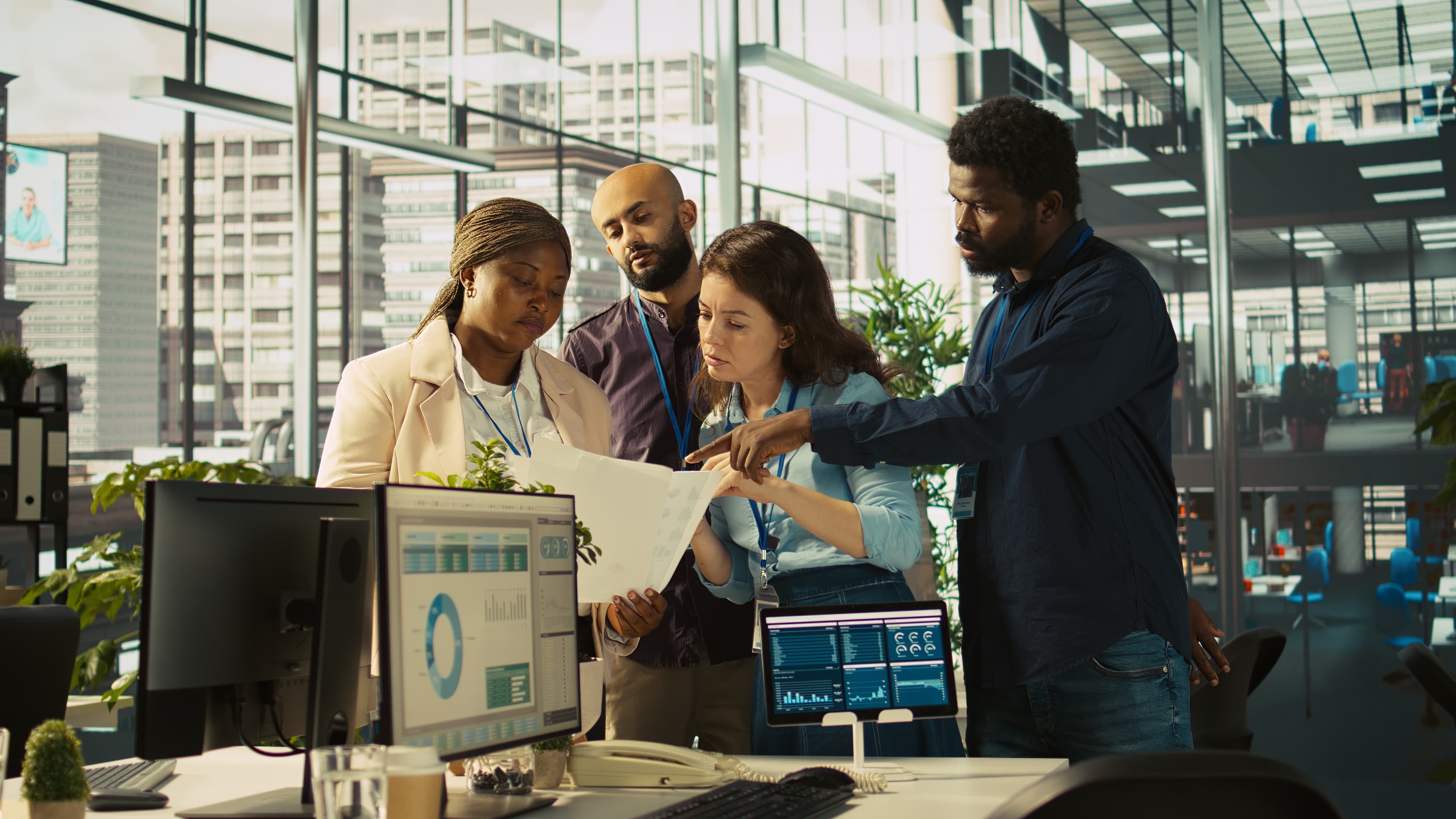 Smiling coworkers reviewing figures together over paperwork