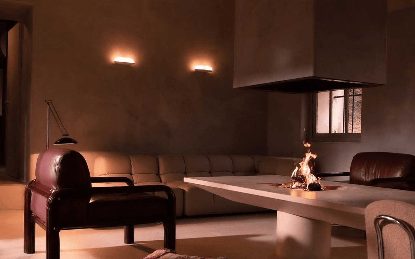 Cozy interior room with a sofa and coffee table/fire pit