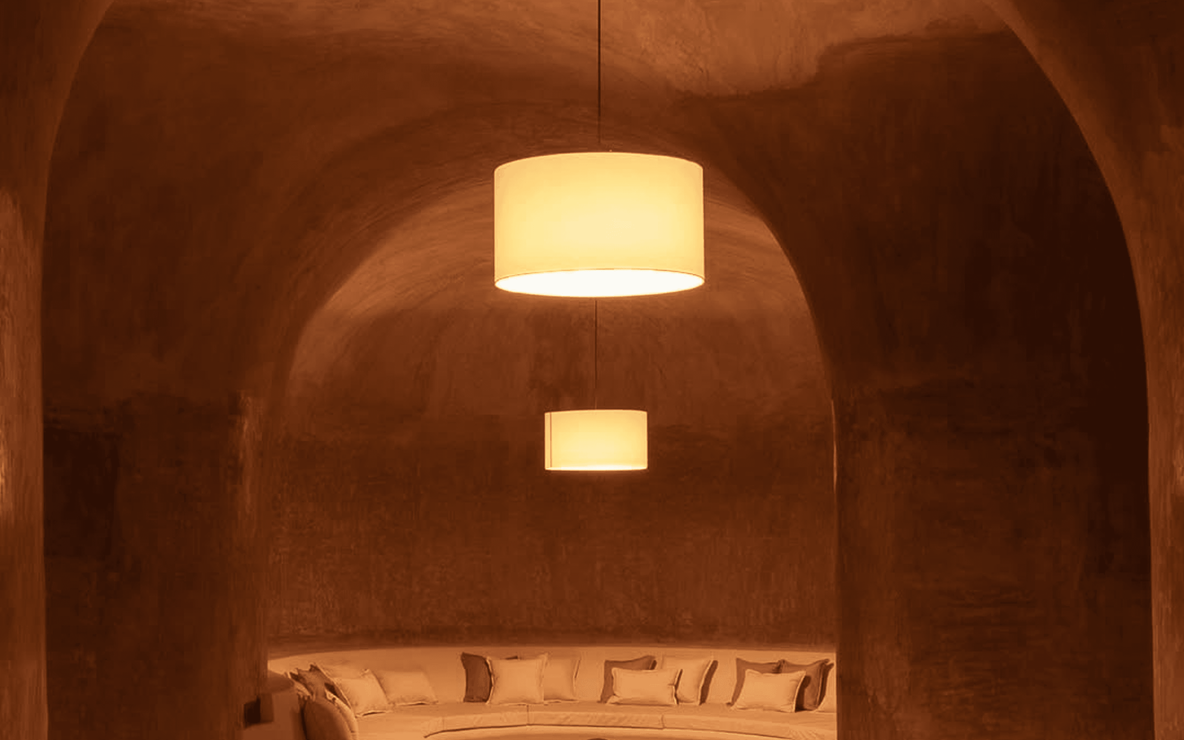 Cozy interior room with a central glowing hanging lamp and warm tones